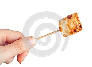 Roasted marshmallows on a skewer on white background
