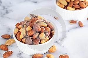 Roasted mixed nuts in white ceramic bowl