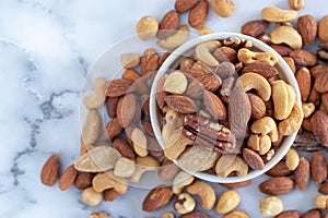 Roasted mixed nuts in white ceramic bowl