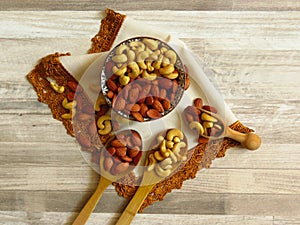 Roasted Natural Almond Nuts Badam and Cashew in a porcelain bowl. photo