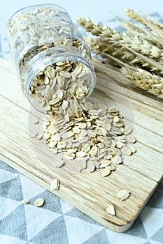 roasted oats flakes spilling from a contianer on table