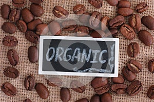 Roasted organic coffee beans and the word Organic