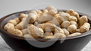 Roasted peanuts in shell. Whole groundnut or unshelled goober nuts