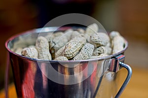 roasted peanuts in a silver cup