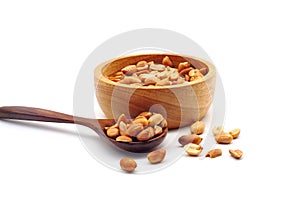 Roasted peanuts in a wooden bolw and spoon
