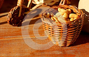 Roasted peeled peanuts in rustic wicker wood basket