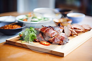 roasted peking duck on a carving board