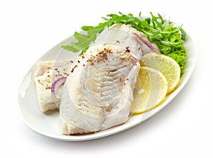 Roasted perch fish fillets on white plate
