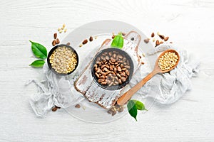 Roasted pine nuts on a white wooden background. ext. Top view