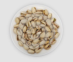 Roasted pistachio nuts on a white plate photo