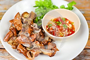 Roasted pork Chitterlings with chilli sauce spicy - entrails intestines part of pork asian thai food photo