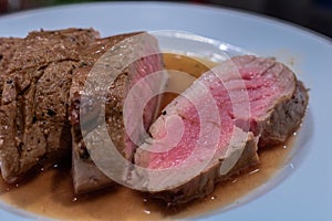 Roasted pork fillet arranged with a white wine and balsamico sauce.