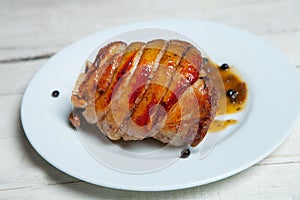 Roasted pork isolated on white plate. Smoked and roasted knuckle of pork on bright background photo