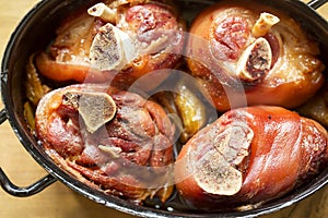 Roasted pork knuckle with onions in beer