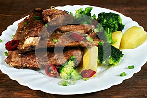 Roasted pork ribs with potatoes and broccoli