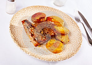 Roasted pork ribs served with fried baked potatoes