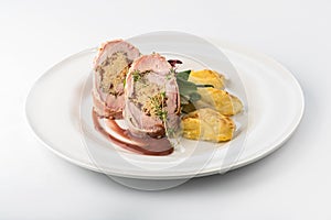 Roasted pork roll stuffed with rice and potatoes