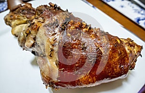 Roasted pork shank served solely on a plate to rest