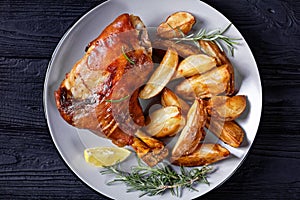 Roasted pork shanks with potatoes on a plate