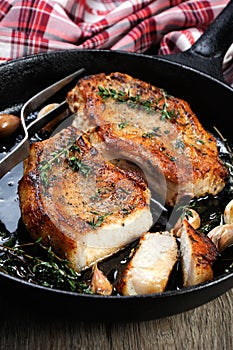 Roasted pork steak in frying pan