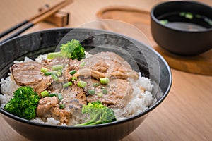 Roasted pork with stir fried broccoli and japanese rice in bowl