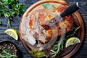 Roasted pork tenderloin on a wooden background photo