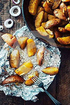 Roasted potato in the panon wooden table. Oven-baked potatoes with sea salt and rosemary. Potato food . Baked potatoes with spices