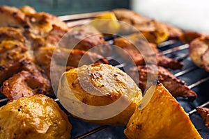 Roasted Potatoes and Chicken Slices on Stainless Steel Cooking Grid