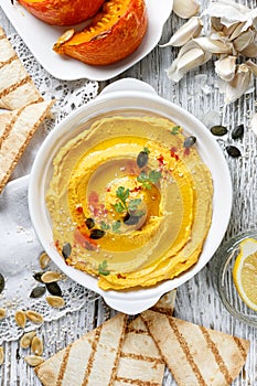 Roasted pumpkin hummus, creamy and delicious dip on a white plate