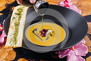 Roasted Pumpkin Soup with toast bread served in bowl isolated on table top view of arabic hot soup