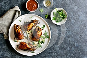 Roasted quails on white plate