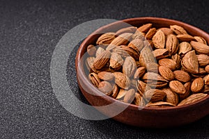 Roasted or raw almond nuts in shell in bowl