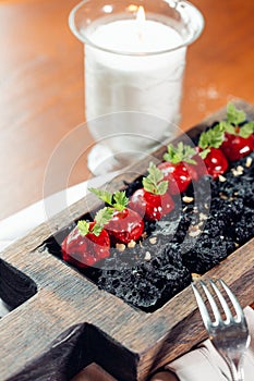 Roasted red beef ribs, meat on bone, black rice on plate