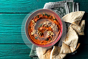 Roasted red bell pepper spread - muhammara - in a red bowl