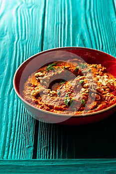 Roasted red bell pepper spread in a red bowl