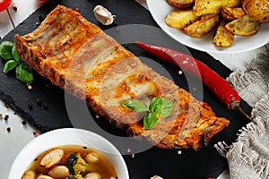 Roasted ribs with herbs and spices. portion of barbecued grilled ribs seasoned with hot spices and fresh herbs