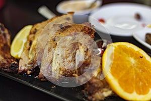 Roasted ribs and orange slices. Portuguese cuisine