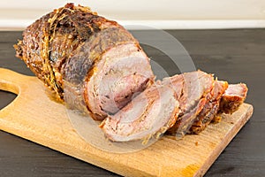 Roasted rolled pork meat on a cutting board