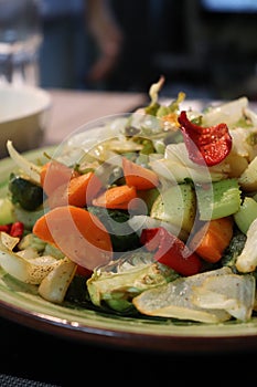 Roasted salad vegetable medley dish, which includes brussels sprouts, carrots, peppers, and celery.