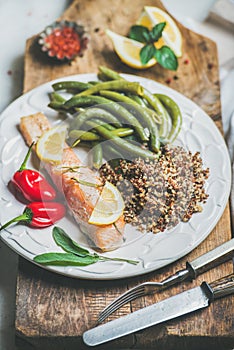 Roasted salmon with quinoa, pepper and poached beans in plate