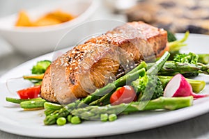 Roasted salmon steak with asparagos broccoli carrot tomatoes rad