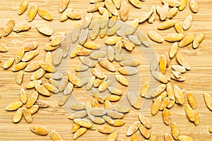 Roasted salted dry melon seeds, on bamboo cutting board