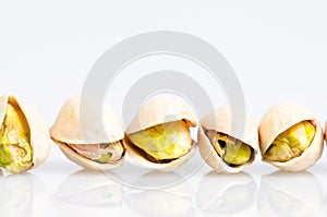 Roasted and salted pistachio in line with reflexion isolated on