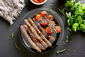 Roasted sausages and cherry tomatoes