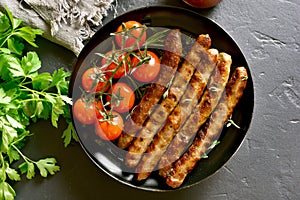 Roasted sausages and cherry tomatoes