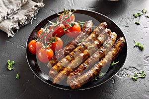 Roasted sausages and cherry tomatoes