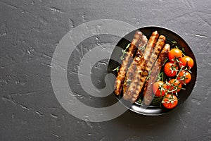 Roasted sausages and cherry tomatoes