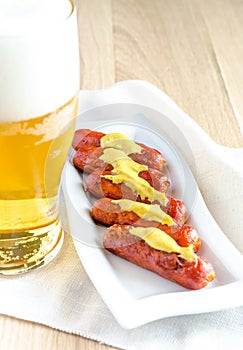 Roasted sausages with glass of beer