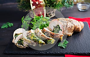 Roasted sliced Christmas roll of turkey with spinach and cheese