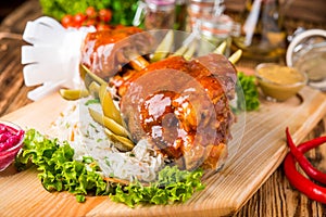 Roasted sliced pork ham and roast vegetables on dark rustic background